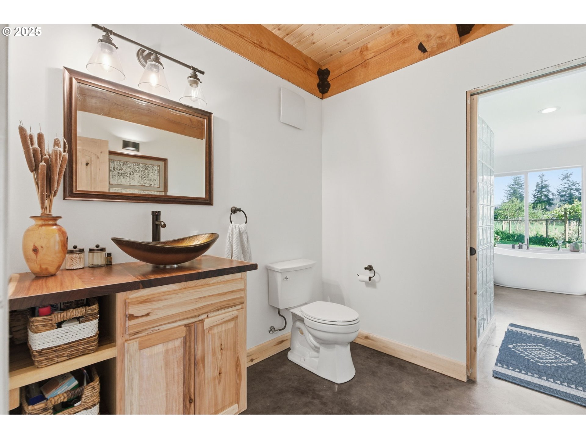 314 East Valley Road Skamokawa, WA 98647 - Photo 12 of 46 a bathroom with a toilet a sink and mirror