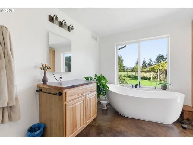 a living room with kitchen island a sink and a large window