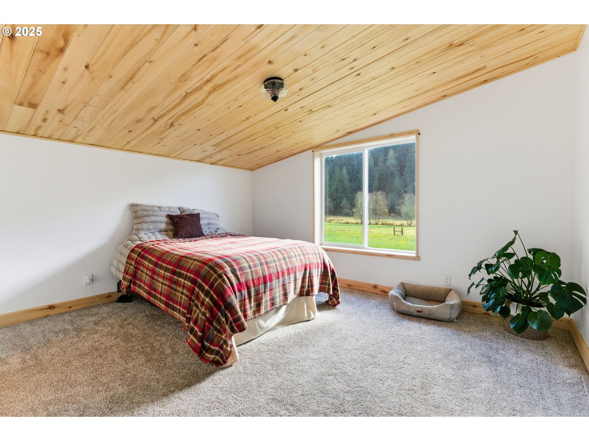 314 East Valley Road Skamokawa, WA 98647 - Photo 18 of 46 a bedroom with a bed and a window