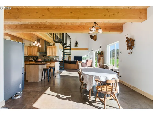 a living room with couches a coffee table and a dining table with wooden floor