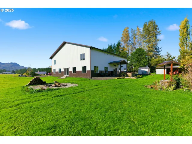 an aerial view of green landscape with trees houses and mountain view