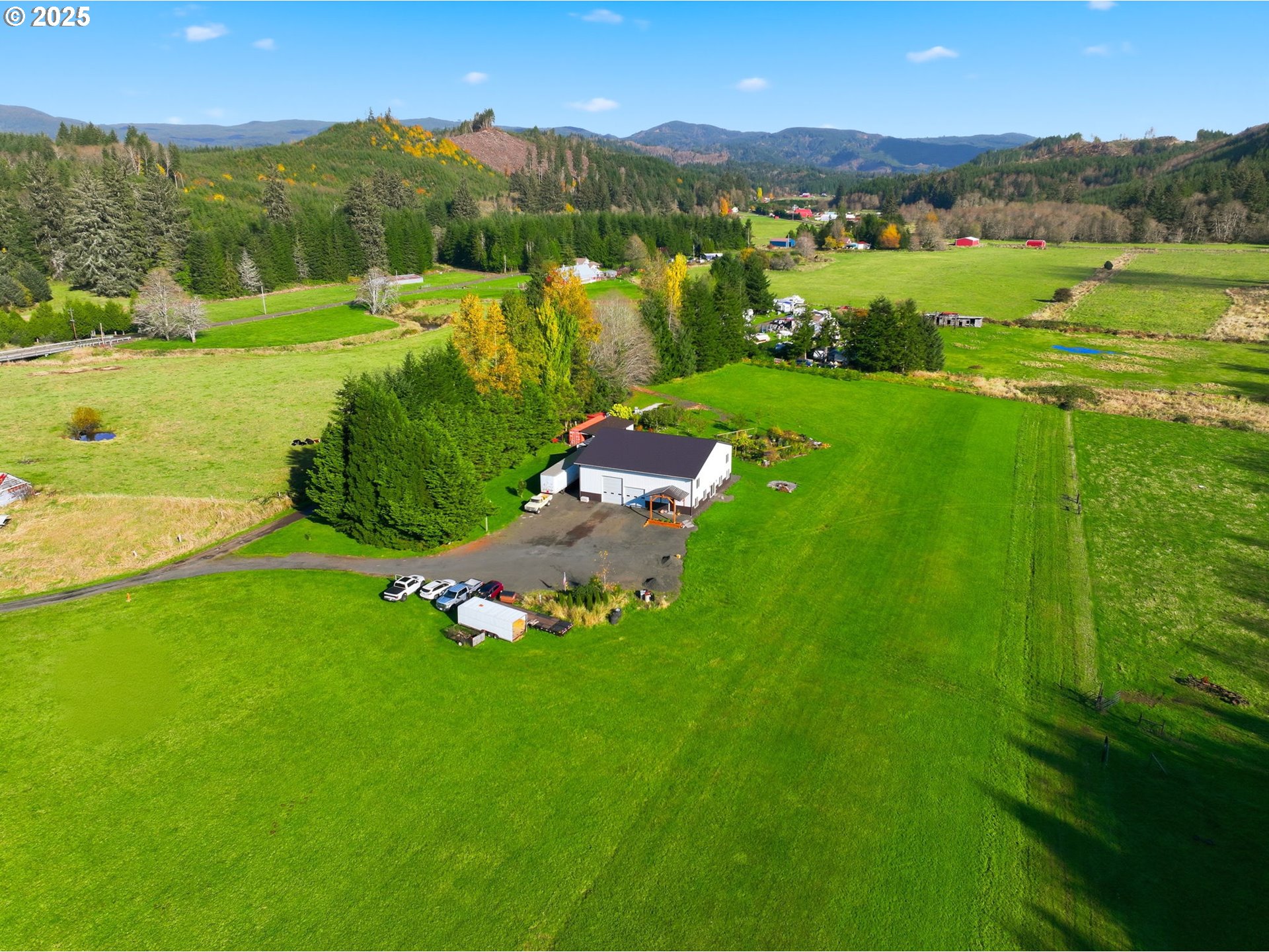 314 East Valley Road Skamokawa, WA 98647 - Photo 37 of 46 an aerial view of green landscape with trees houses and mountain view