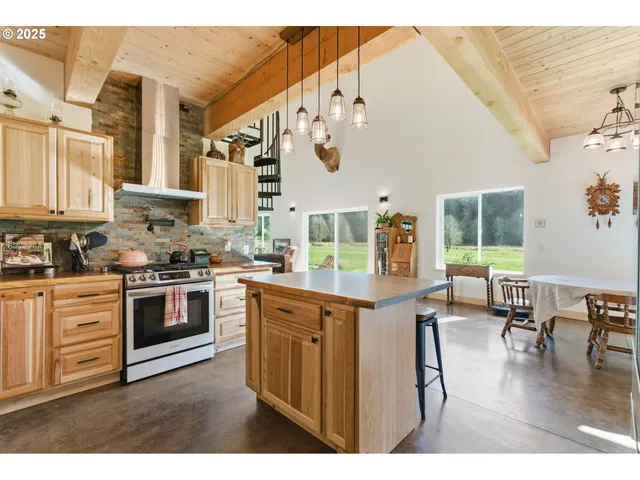 a kitchen with stainless steel appliances granite countertop a stove and cabinets