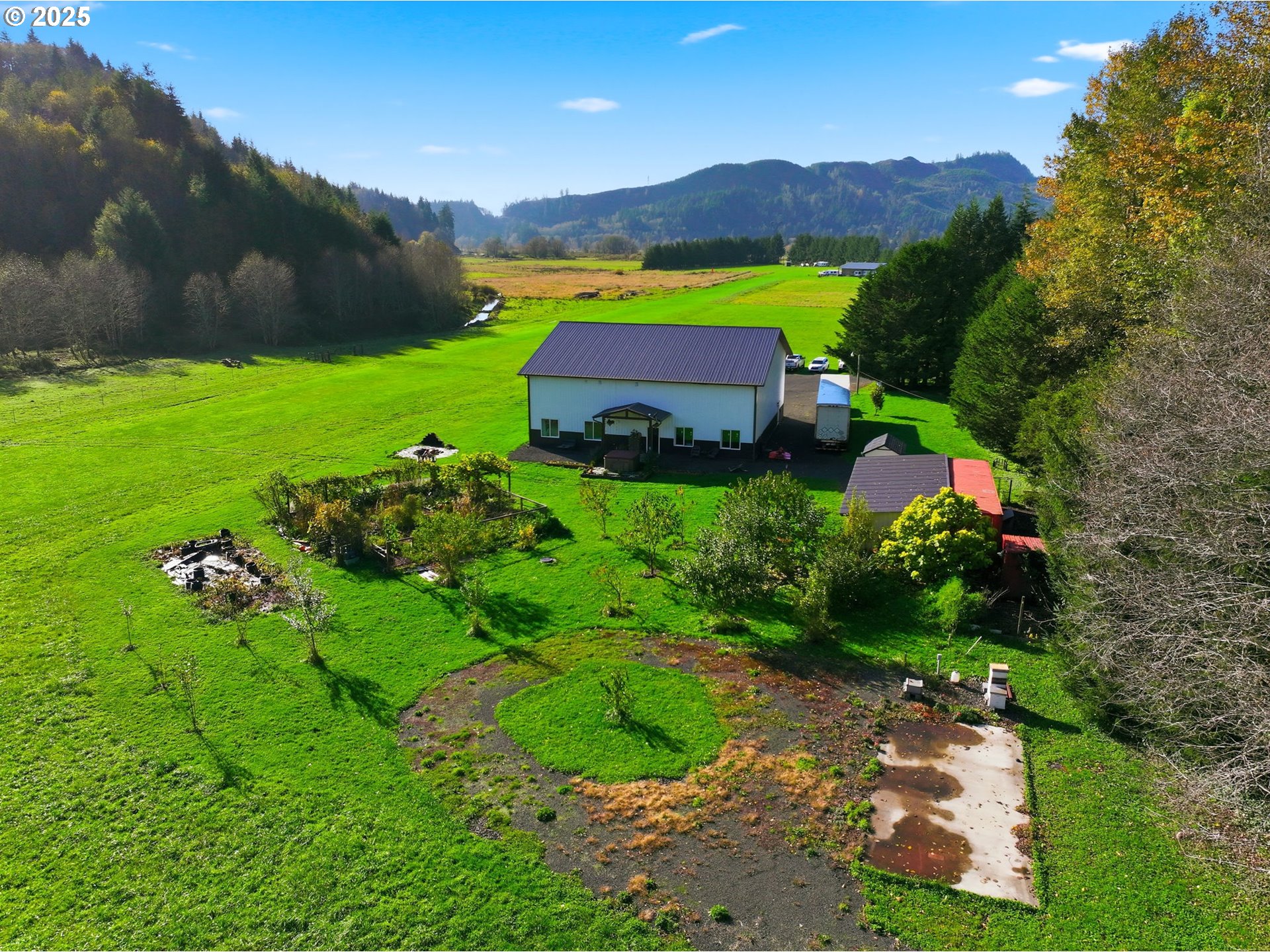 314 East Valley Road Skamokawa, WA 98647 - Photo 43 of 46 a view of a lush green house with a yard and mountain