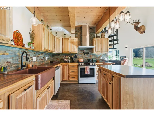 a kitchen with stainless steel appliances granite countertop a stove a sink dishwasher and cabinets with wooden floor