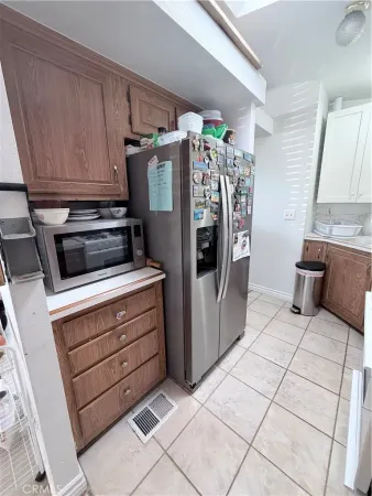 a kitchen with stainless steel appliances kitchen island granite countertop a refrigerator and a stove