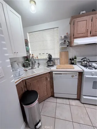 a kitchen with a sink a stove and cabinets
