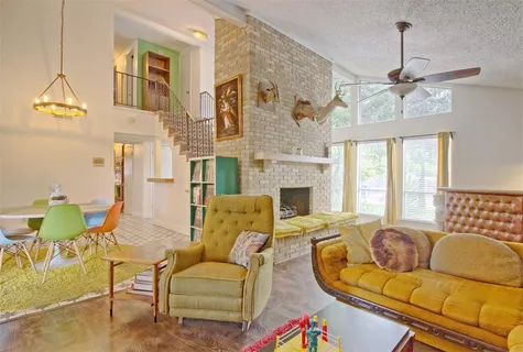 a living room with fireplace furniture and a chandelier