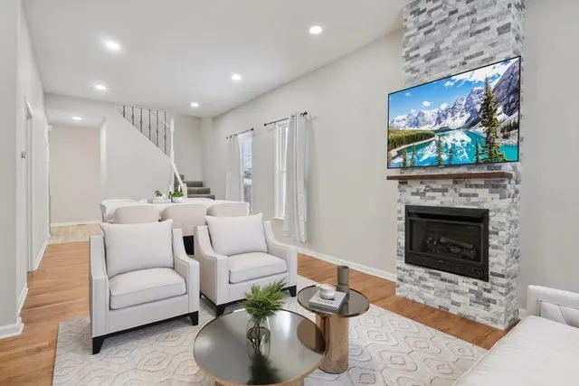 a living room with furniture a fireplace and a flat screen tv