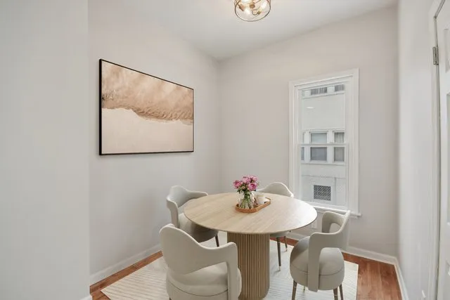 a view of a dining room with furniture and wooden floor