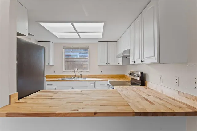 a spacious bathroom with a tub sink and mirror