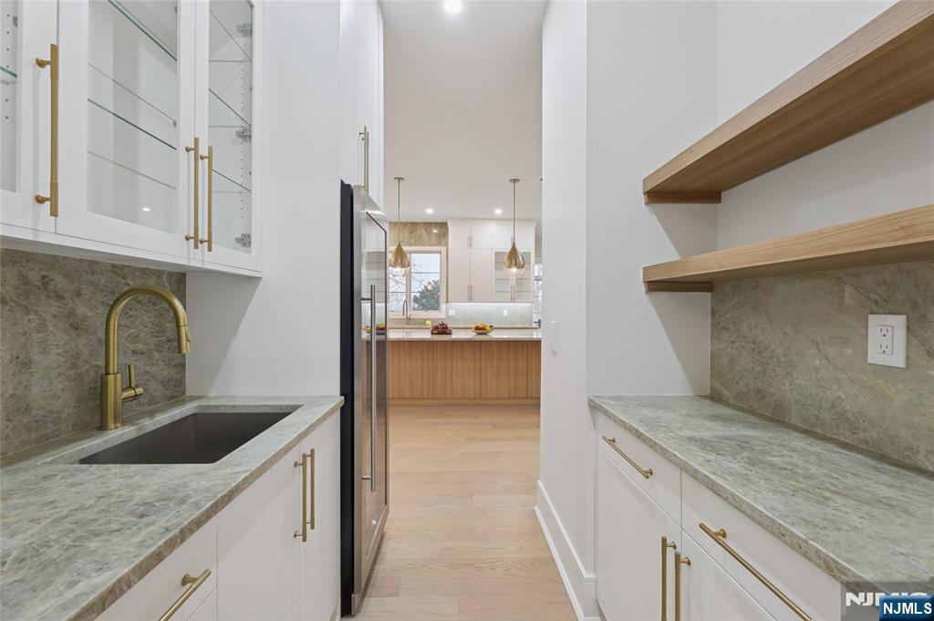 311 North Farview Avenue Paramus, NJ 07652 - Photo 16 of 50 a kitchen with granite countertop a sink and a stove