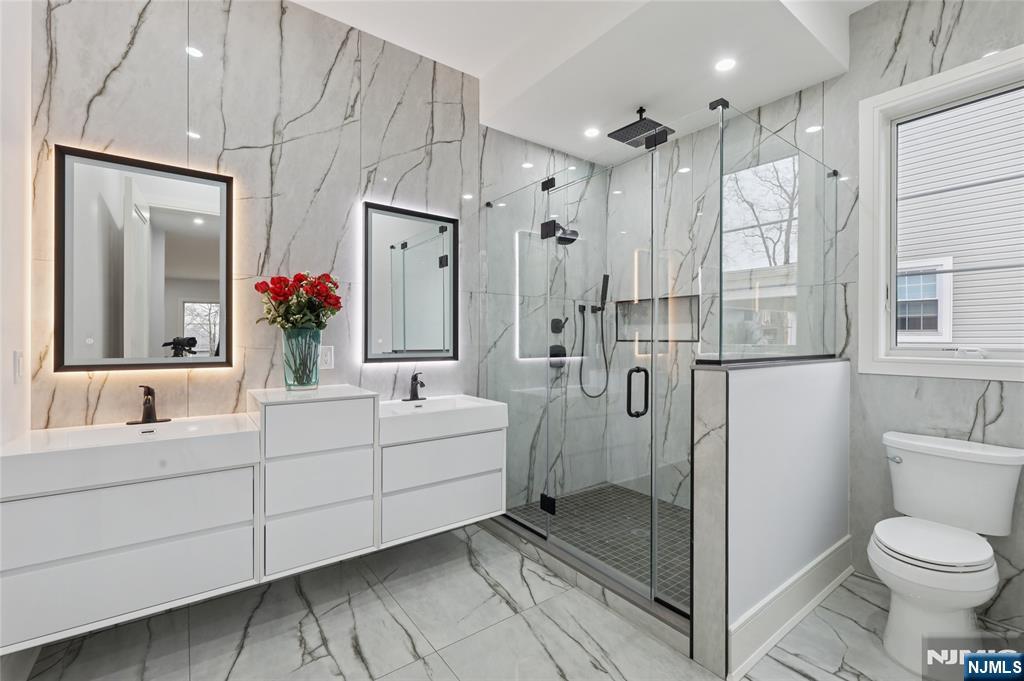 311 North Farview Avenue Paramus, NJ 07652 - Photo 20 of 50 a bathroom with a double vanity sink mirror and shower