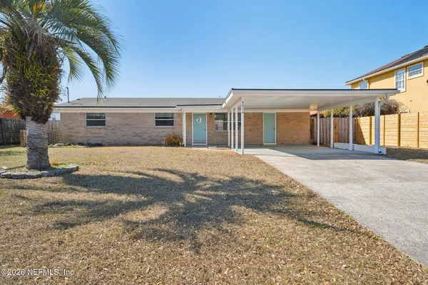 a front view of a house with a empty space and garage