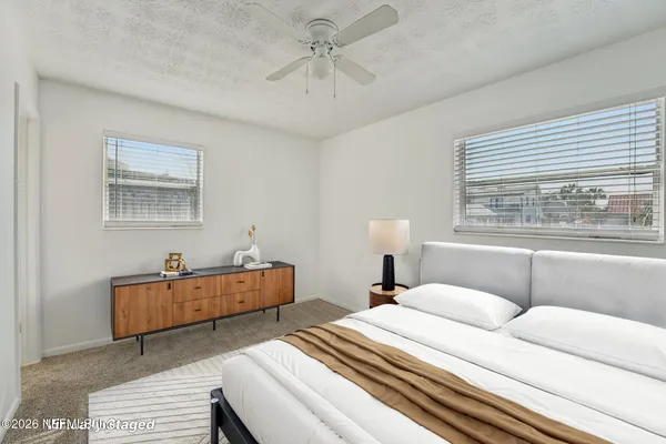 a bedroom with bed and window