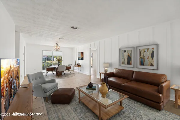 a living room with furniture and a rug