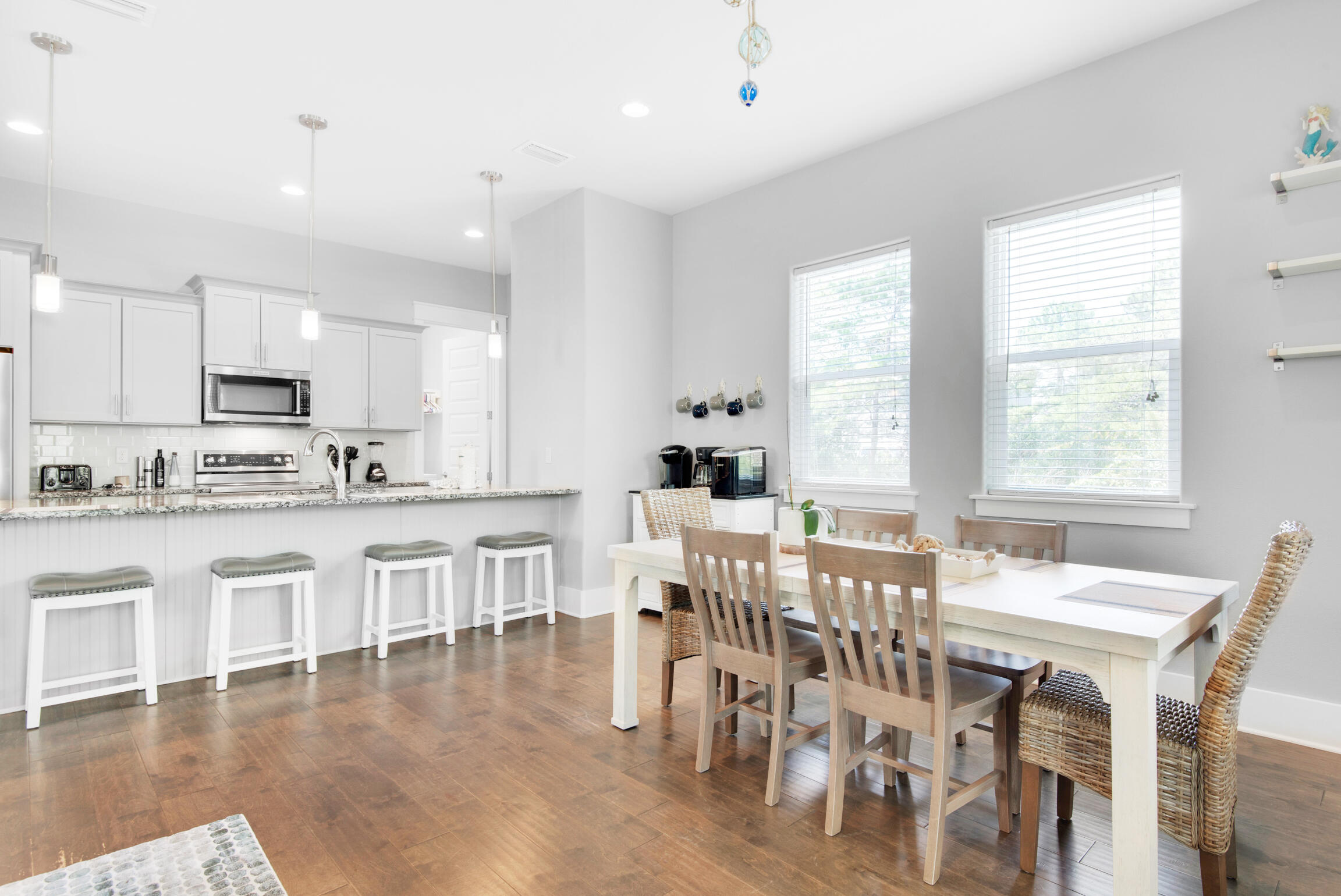 23 Mobile Street Miramar Beach, FL 32550 - Photo 11 of 49 a large kitchen with kitchen island a dining table chairs and white cabinets