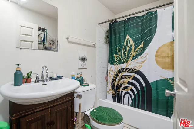 a bathroom with a sink a mirror and a bathtub