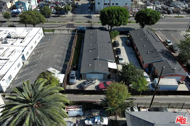 an aerial view of multiple houses with yard