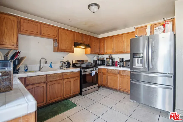 a kitchen with a refrigerator stove and sink