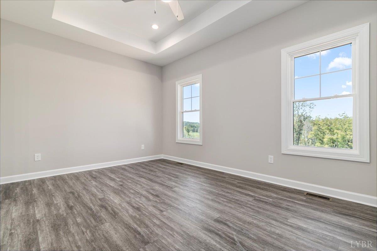 9768 Leesville Road Evington, VA 24550 - Photo 11 of 37 an empty room with wooden floor and windows