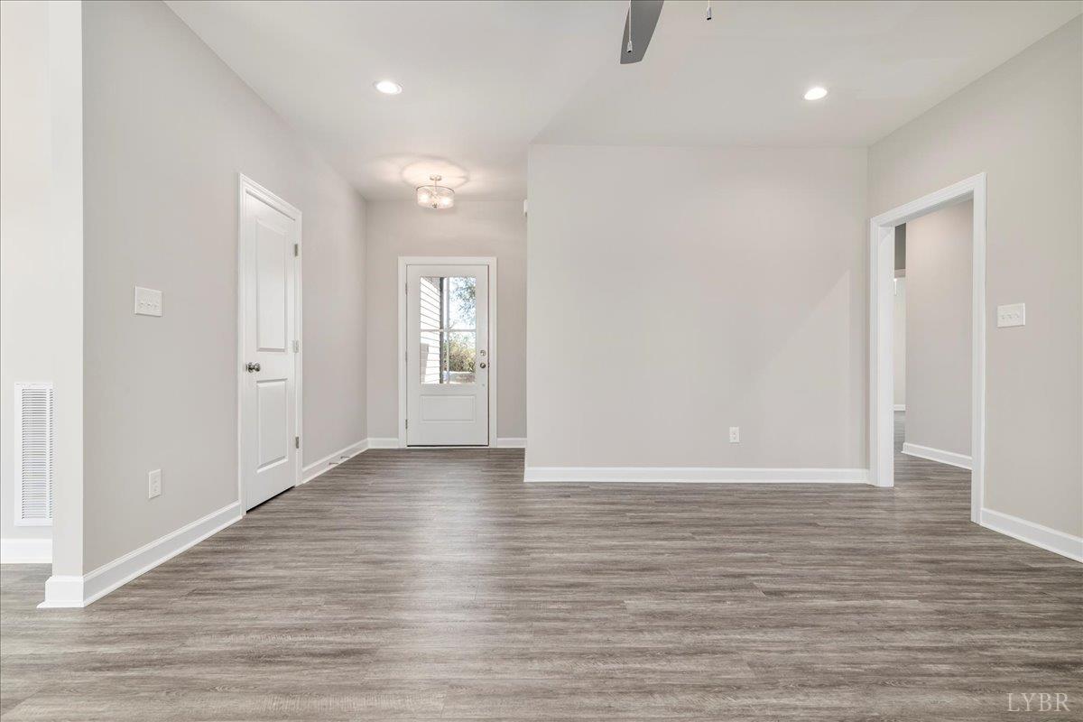 9768 Leesville Road Evington, VA 24550 - Photo 29 of 37 a view of an empty room with wooden floor and a window