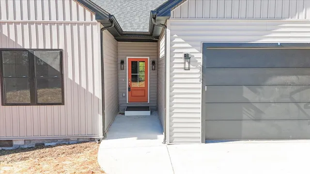 a view of a house with a door and wooden floor