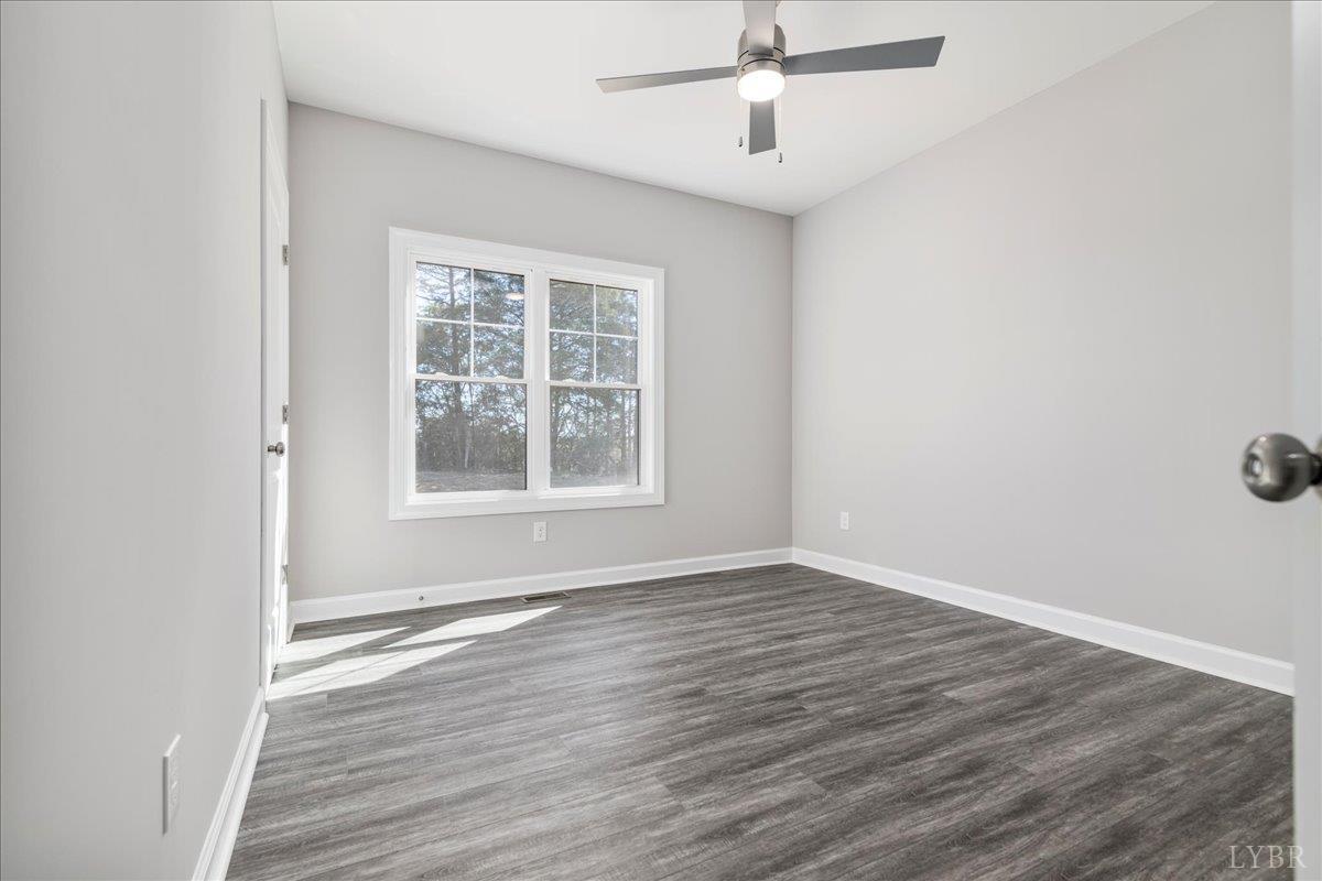 9768 Leesville Road Evington, VA 24550 - Photo 8 of 37 wooden floor in an empty room with a window