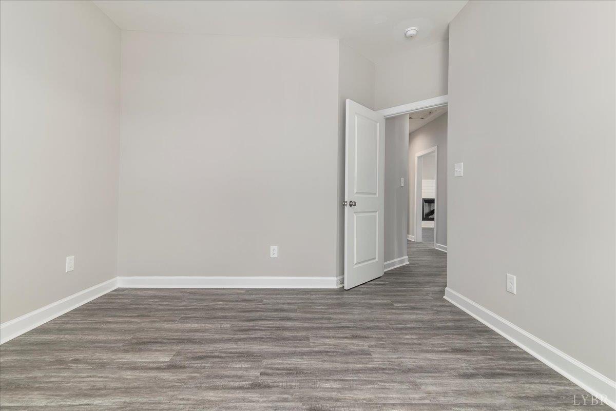 9768 Leesville Road Evington, VA 24550 - Photo 9 of 37 a view of an empty room with wooden floor and closet