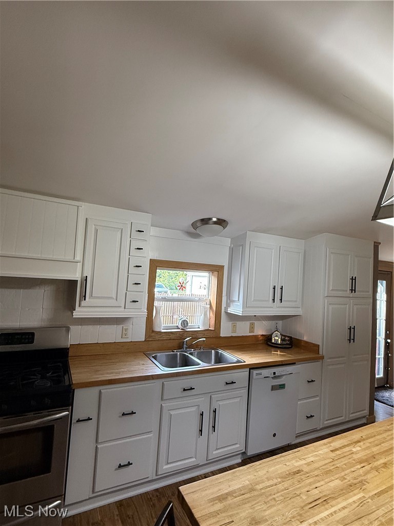 3868 Cook Road Rootstown, OH 44272 - Photo 13 of 44 Kitchen with Butcher Block counters, range, dishwasher, and white Kraft Maid cabinetry