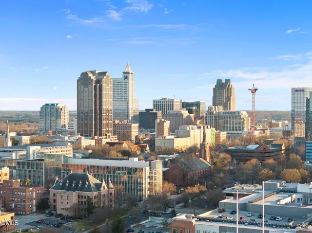 a view of a chandelier in big room and a bathroom