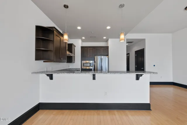 a kitchen with a refrigerator and cabinets