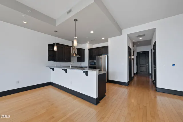 a kitchen with stainless steel appliances granite countertop a sink and a stove