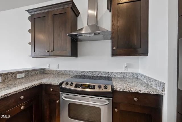 a large kitchen with stainless steel appliances granite countertop a large counter top stainless steel appliances and cabinets