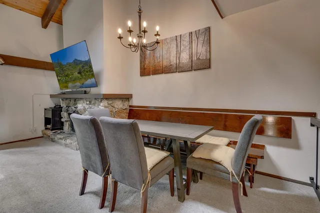 a view of a dining room with furniture and chandelier
