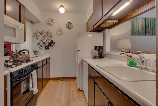 a kitchen with stainless steel appliances granite countertop a stove and a sink