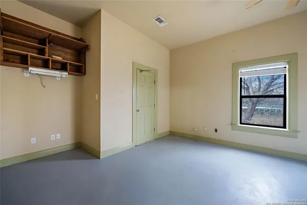 an empty room with windows and closet