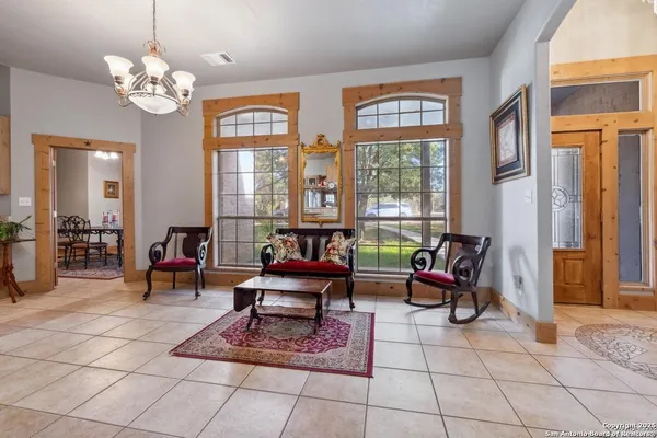 a living room with furniture a table and large windows