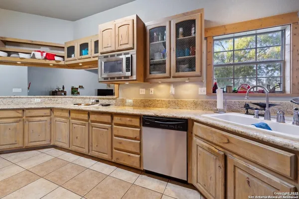 a kitchen with cabinets appliances and a sink