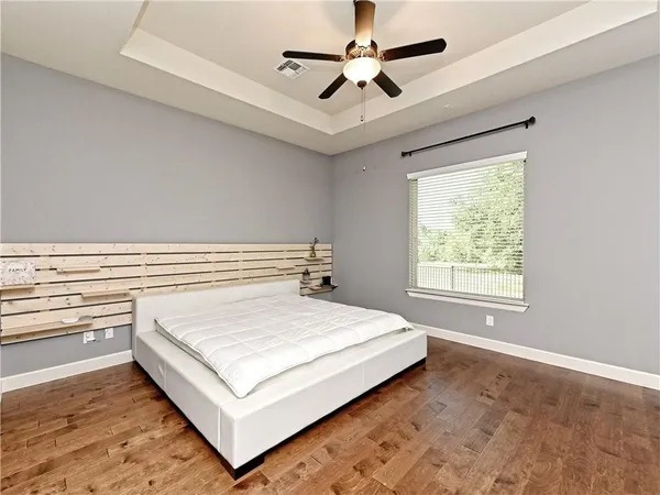 a bedroom with a bed and a large window