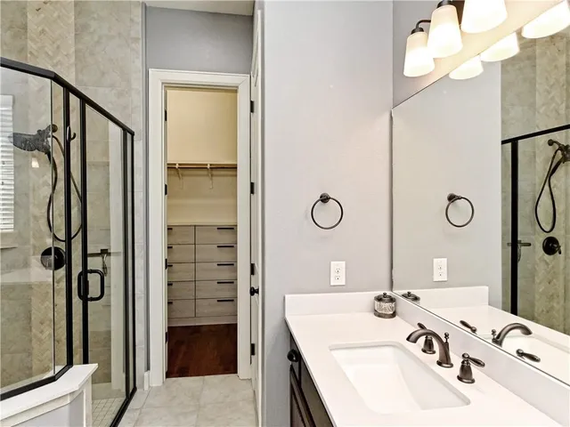a bathroom with a sink double vanity and shower