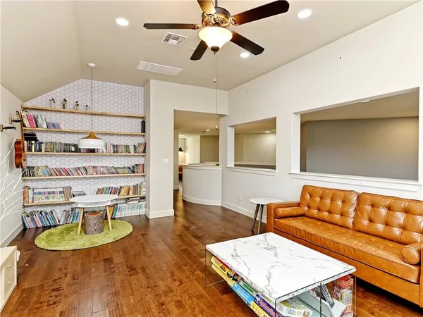 a living room with furniture and wooden floor