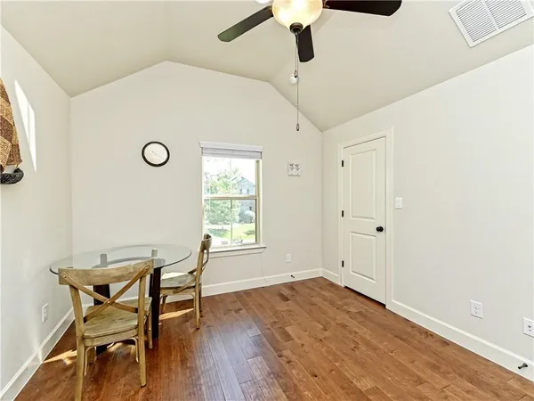 a view of a room with wooden floor and windows