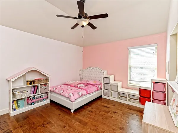 a bedroom with a bed dresser and a window