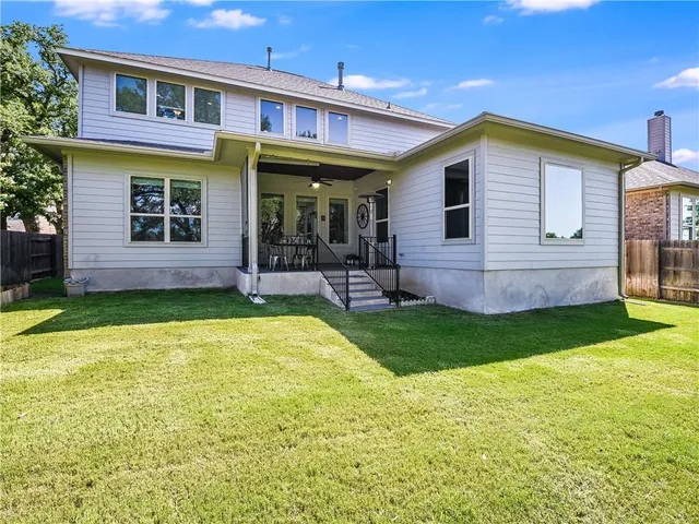 a view of a house with a yard patio and swimming pool