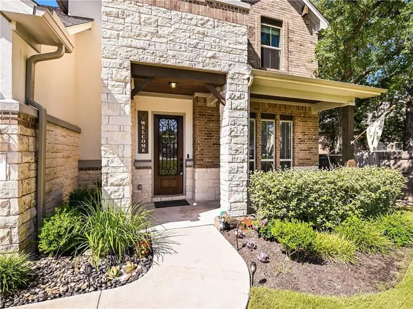 a front view of a house with garden
