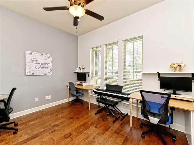 a view of a workspace with furniture and a window