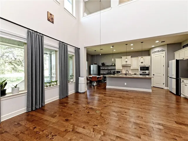 a view of kitchen with kitchen island granite countertop cabinets and a counter top space