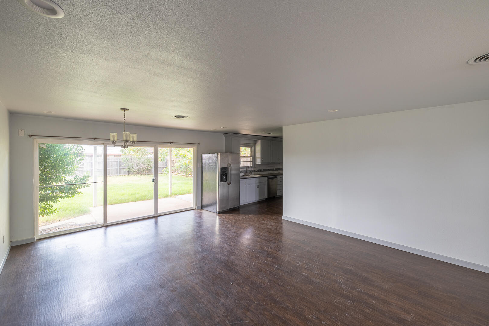 5403 13th Street Lubbock, TX 79416 - Photo 11 of 28 wooden floor in an empty room with a window