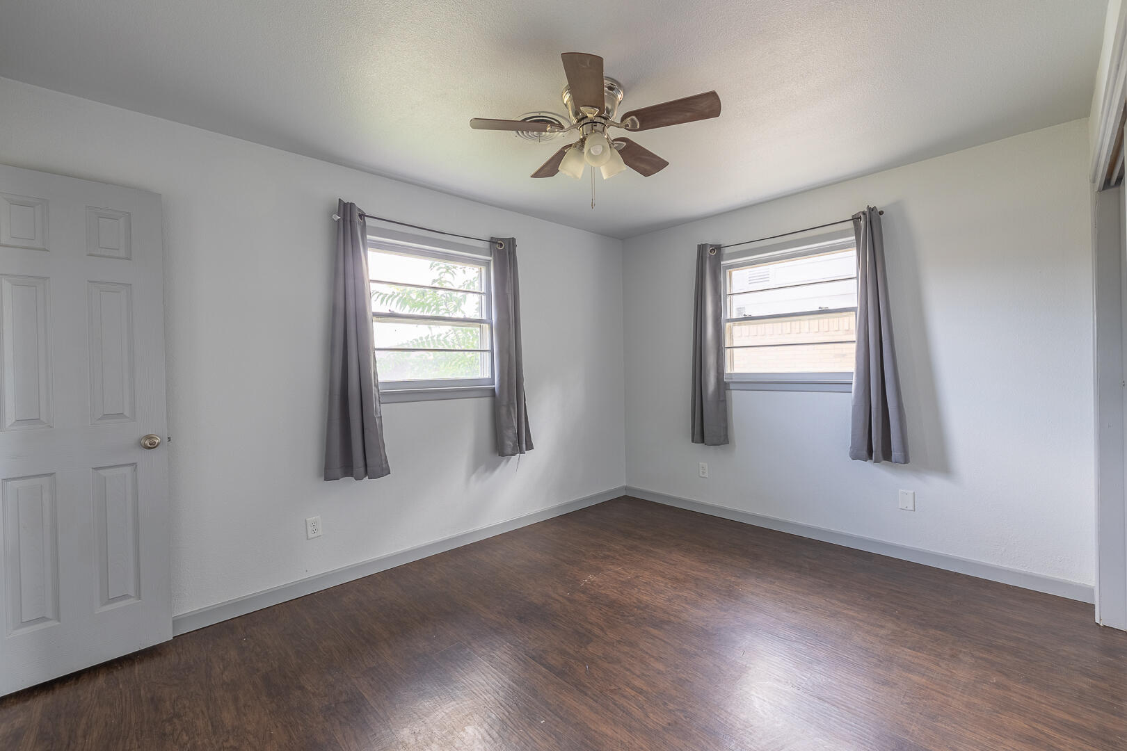 5403 13th Street Lubbock, TX 79416 - Photo 15 of 28 a view of an empty room with a window and wooden floor